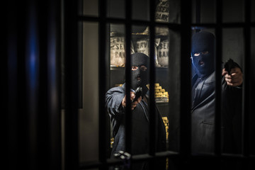 Fototapeta na wymiar Two ardmed men robbing a bank