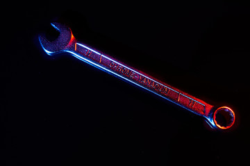 Wrench on black background with reflections. Mixed lighting