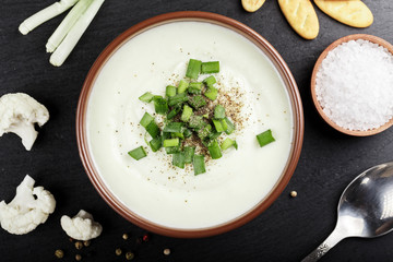 cream soup in a plate on a black background