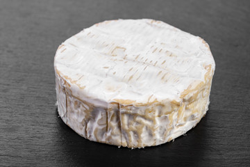 brie cheese on black background