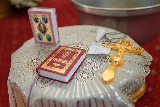 golden cross bible and details for christening in the orthodox temple interior