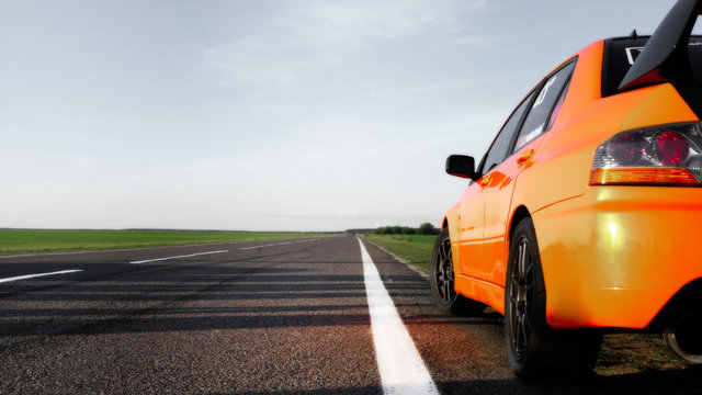 Powerful Orange Car Stands On The Side Of The Road And Ready To Race