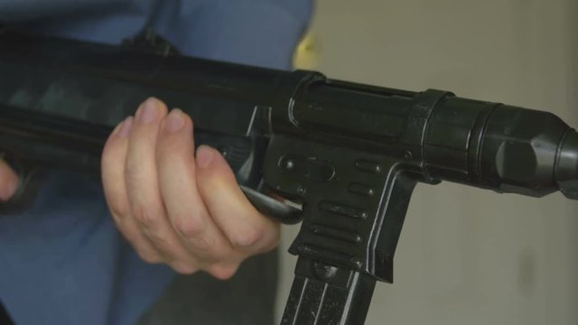 holding a gun up in arms