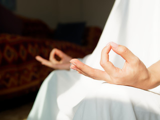 Close up Hand Gesture of Woman in white robe Doing Lotus Yoga Position, an Activity to Stay...