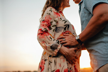 young happy beautiful couple in love walking together on grass