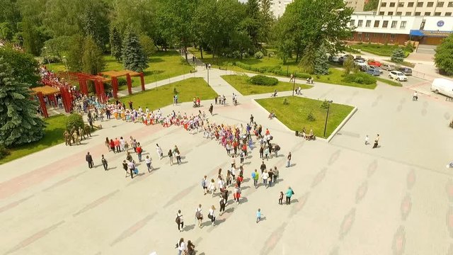 Aerial view of column with participants in the parade of dance groups enters the city park. Ternopil Ukraine.