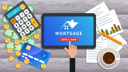 Mortgage loan online. Buy real estate, home mortgage. Flat tablet with house logo and hand clicking apply now button on desk with credit card, calculator, cash, cup of coffee, paper chart and pencil