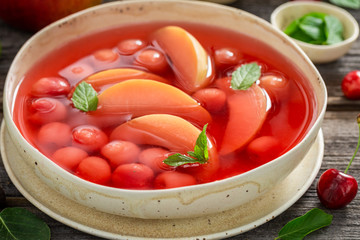 Sweet and homemade fruit soup in hot summer garden