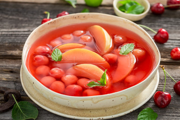 Sweet fruit soup with fresh apples and cherries