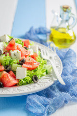 Fresh Greek salad with lettuce, tomatoes and onion