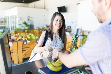 Woman Buying Some Groceries At A Supermarket