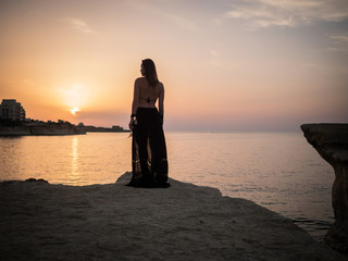 Woman looking on a resort town at dusk