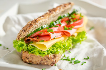Tasty sandwich with cheese, ham and chive for breakfast