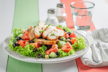 Delicious Caesar salad with tomatoes and lettuce and olives