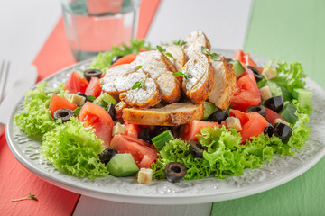 Fresh Caesar salad with chicken, tomatoes and lettuce
