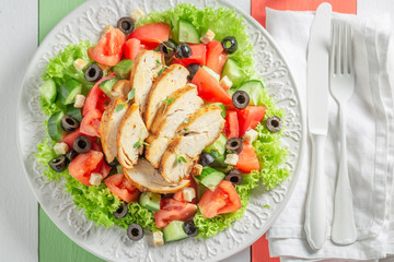 Fresh Caesar salad with tomatoes and lettuce and olives