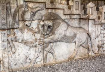 Bas-relief in Persepolis, the Symbol of Navruz in Zoroastrianism - the sacred battle of the bull , symbolizing the moon and the Lion, symbolizing the Sun on the stairs of Apadana.