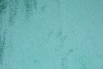 the texture of old turquoise paint with cracks.