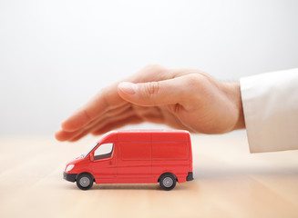 Transport red van car protected by hand