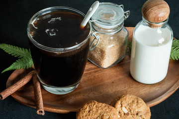 Glass of coffee with brown sugar and milk