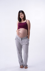 The pregnant woman standing and put hand touching her bellywith love and care,waiting for New born,on white background