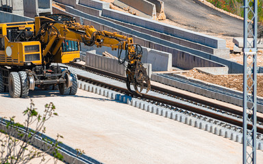 Close up rail excavator on reconstruction of the railway rails