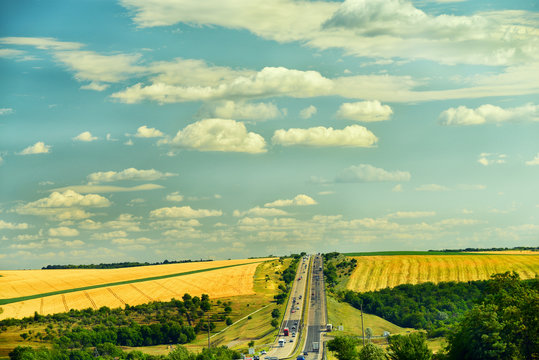 The route stretches upwards and open spaces of different pole with harvested crops along the road. The route Kiev-Odessa. Route E95.