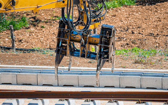 Close up rail excavator on reconstruction of the railway rails