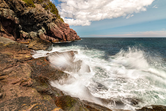 Dramatic seascape with waves crashing on a rocky coast. © Scott Heaney