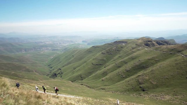 Group of people hiking in the beautiful green Drakensberg moutains in South Africa