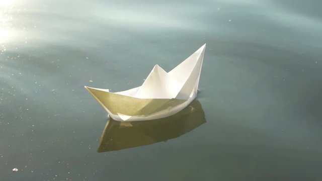 paper boat in lake water