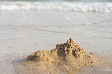 Sand castles destroyed by sea water But the remains of the ruined soil Summer concept Unsustainable and uncertain