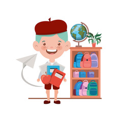 student boy with school supplies in the classroom