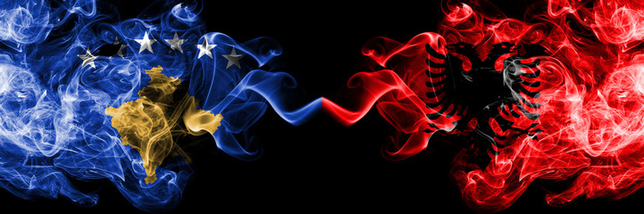 Kosovo vs Albania, Albanian smoky mystic flags placed side by side. Thick colored silky smokes combination of Kosovo and Albania, Albanian flag