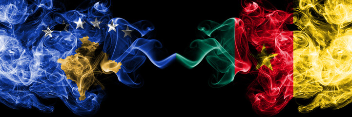 Kosovo vs Cameroon, Cameroonian smoky mystic flags placed side by side. Thick colored silky smokes combination of Kosovo and Cameroon, Cameroonian flag