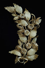Fototapeta na wymiar Decoration of straw on a black background. Branch with flowers. Decor.