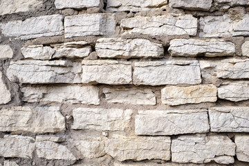 Old stone wall of different stones, texture for your design.