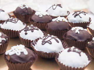 Many delicious cupcakes are on the table.
