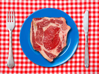 Blue dinner plate with fork and knife
