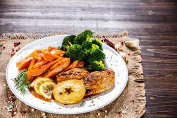 Grilled chicken breast, French fries and vegetable salad