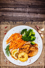 Grilled chicken breast, French fries and vegetable salad