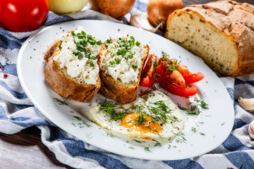 Breakfast - fried egg, toasts and vegetable salad
