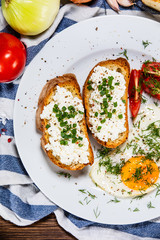 Breakfast - fried egg, toasts and vegetable salad