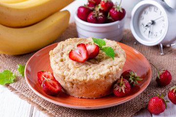 Fresh homemade cake in the microwave with fresh strawberries