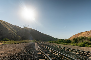 railway in mountains with blue sky and clouds