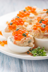 Stuffed eggs with red caviar.