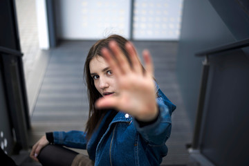 Portrait of a young caucasian lady with freckles on club stairs