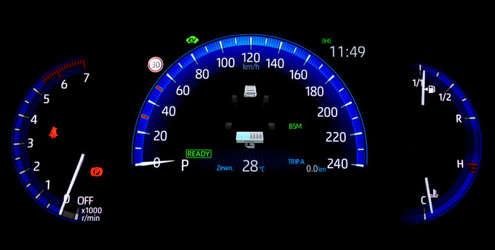 Car counter in hybrid vehicle. Instrument panel with display indicating battery charge level, speedometer, tachometer, odometer, fuel gauge and oil temperature gauge. Blue illuminated display.