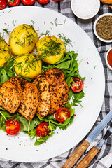 Grilled chicken fillet and vegetables on white plate