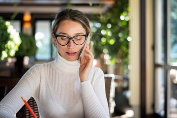 Happy charming beautiful young blonde woman working